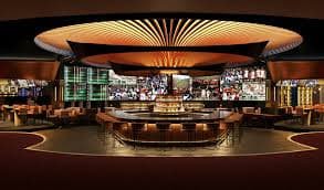 Live casino dealer at blackjack table with multiple camera angles